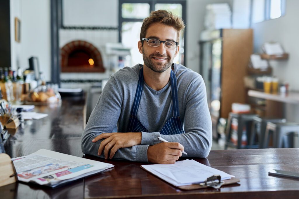 Small-business owner reviewing strong results at their counter